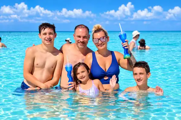 Ashley, her husband, and their three children together on a beach vacation