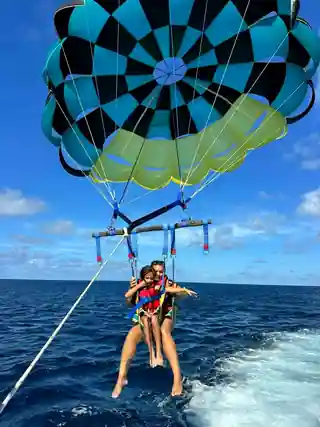 Ashley parasailing with her daughter during a Caribbean cruise excursion